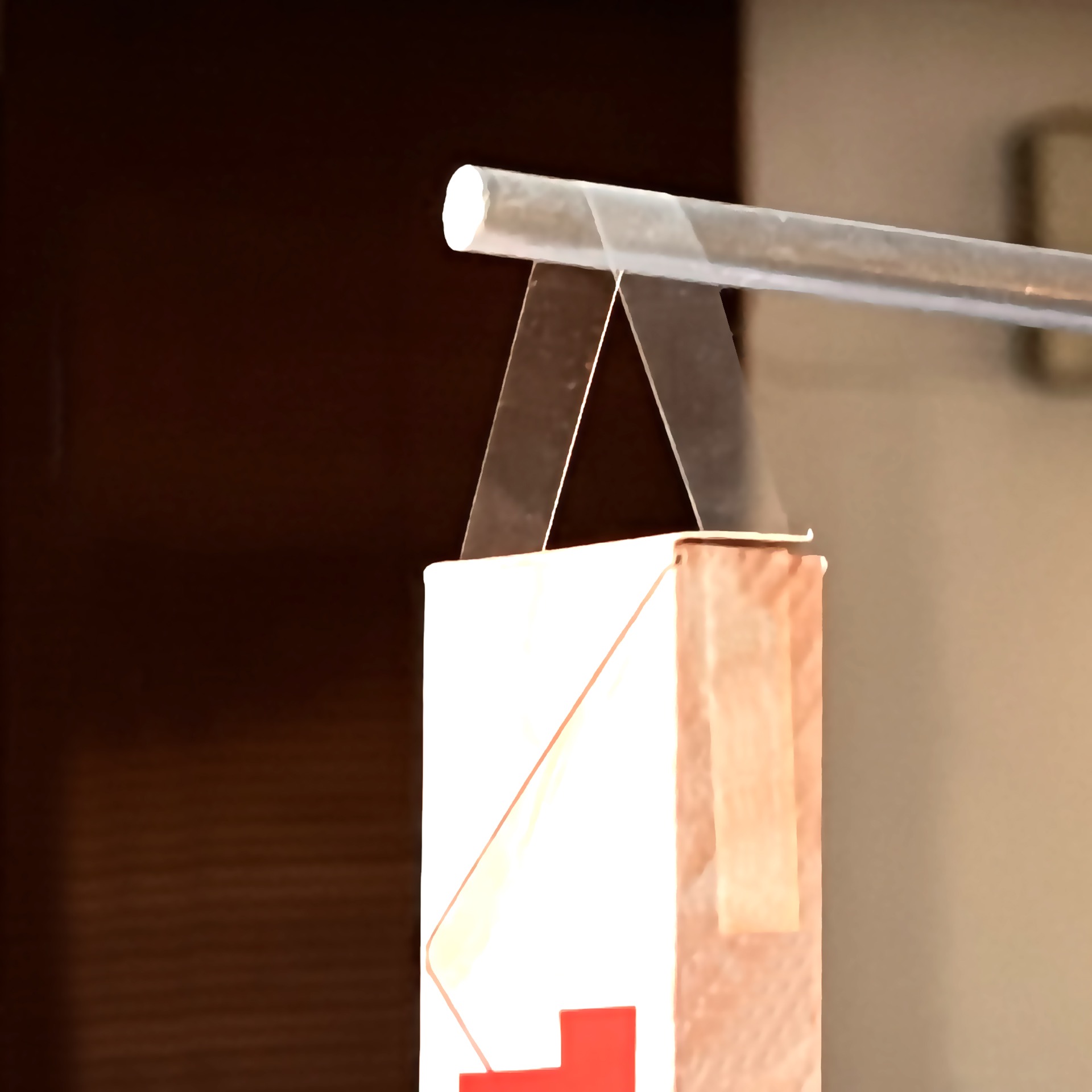 Hang your products without hanging holes on shop stand bars with adhesive hanging strips